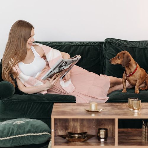 A person sitting calmly in a bright room, looking peaceful and content.
